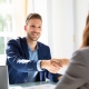 small business owner hiring an accountant and shaking hands