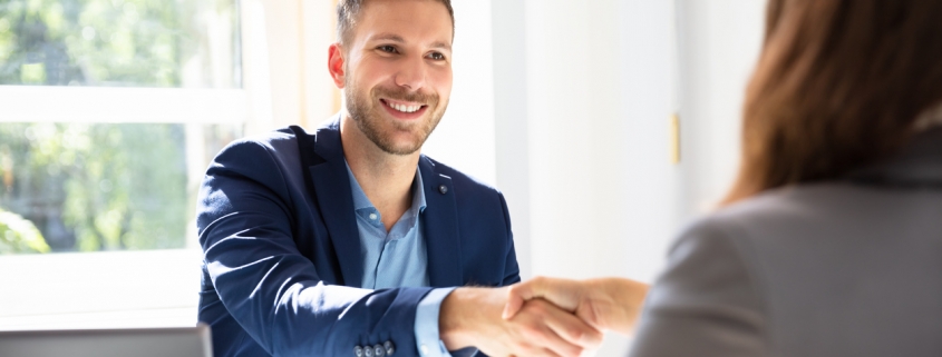 small business owner hiring an accountant and shaking hands