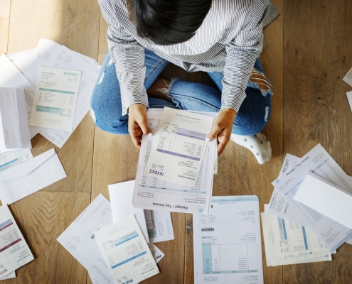 women organizing tax forms on the floor