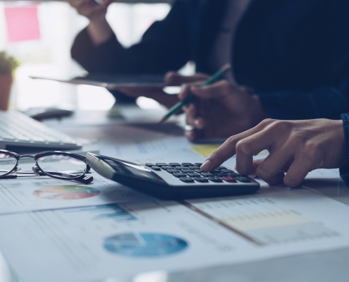 two people calculating business taxes at a desk