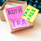 box of money with Roth IRA Tax Free written on sticky notes