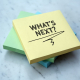 a pile of post-it notes reading what’s next