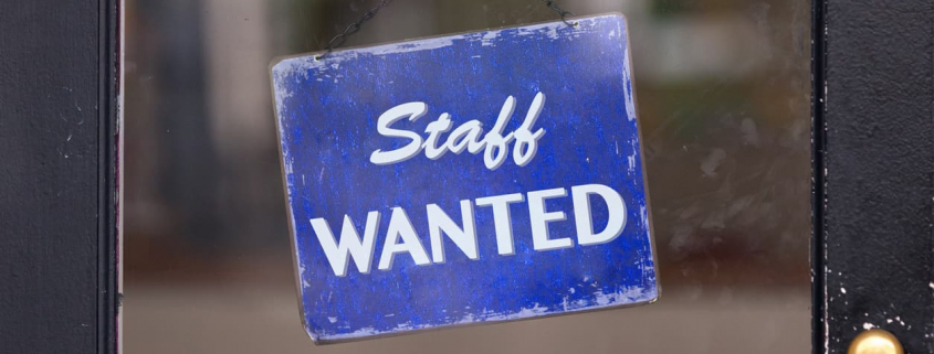staff wanted sign hanging in a business window