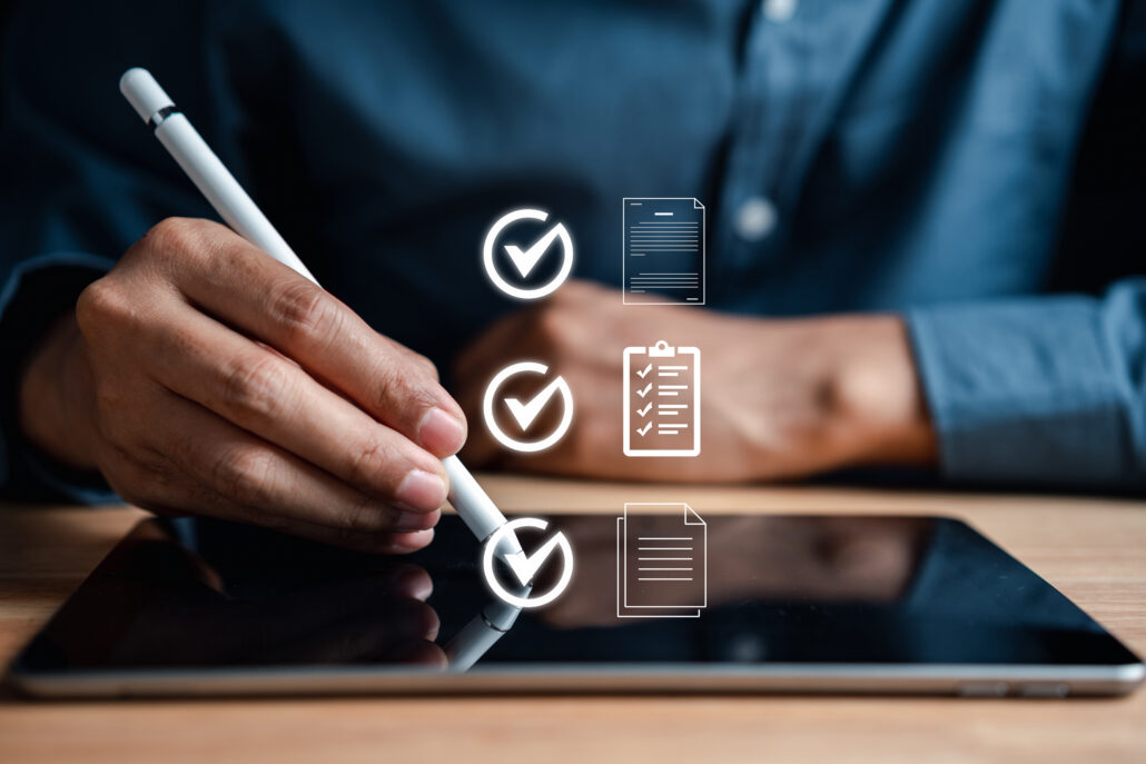 Hand using a stylus on a tablet with checklist icons, representing automated finance tasks and review guardrails for high earners