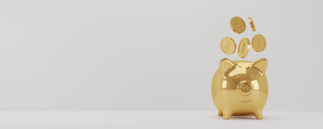 Gold piggy bank with falling coins representing gold in an IRA rules and tax planning