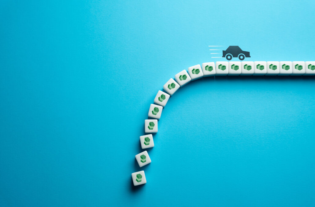 Minimalist illustration showing a path of dollar-sign tiles leading to a business building, representing business vehicle depreciation and tax savings strategies